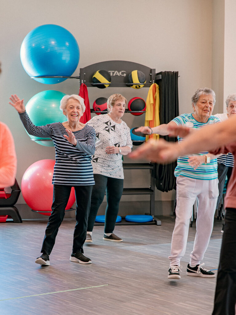 Older adults enjoying a group fitness activity at a senior living community.