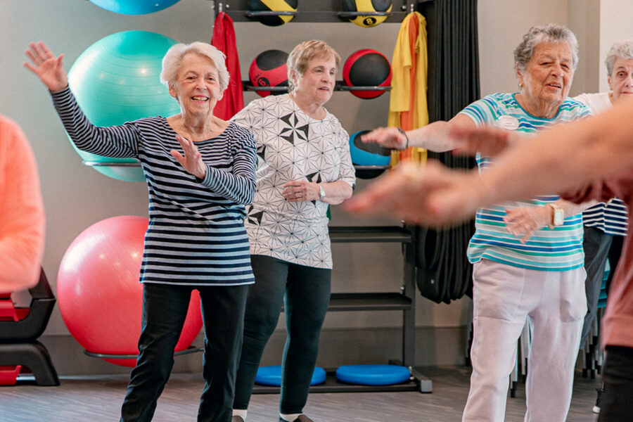 Older adults enjoying a group fitness activity at a senior living community.