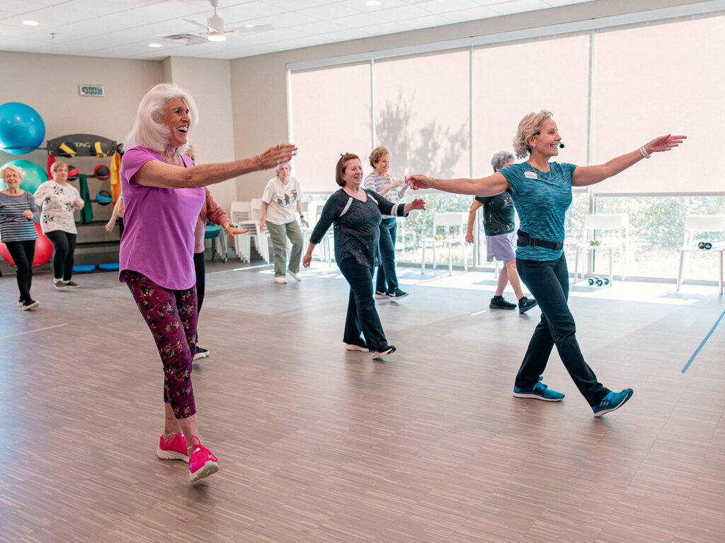 Seniors participating in a summer workout class at a senior living community