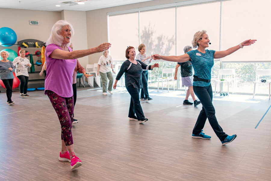Seniors participating in a summer workout class at a senior living community