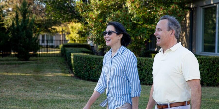 Senior couple walks the grounds at a senior living community