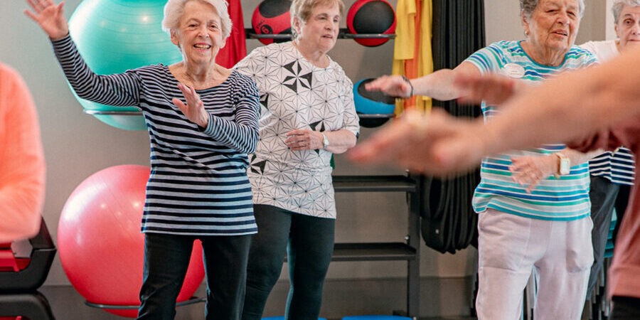 Older adults enjoying a group fitness activity at a senior living community.