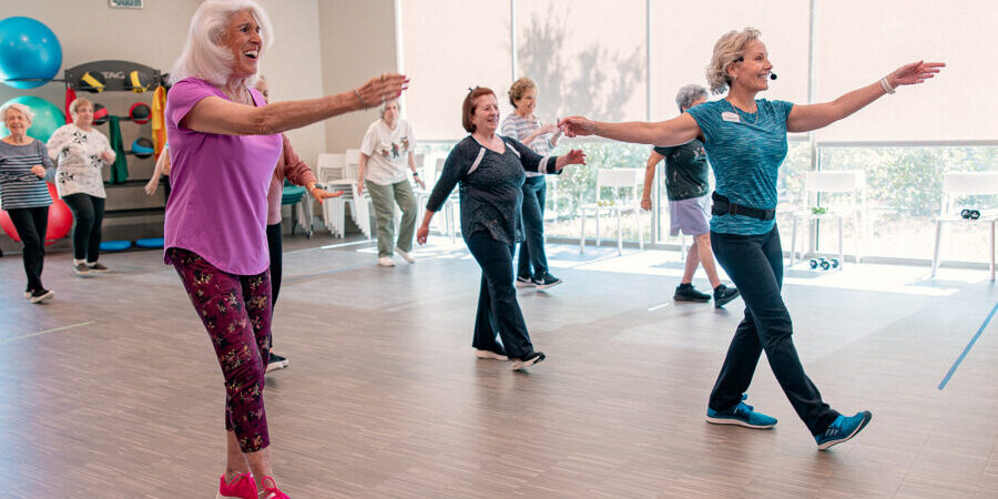 Seniors participating in a summer workout class at a senior living community