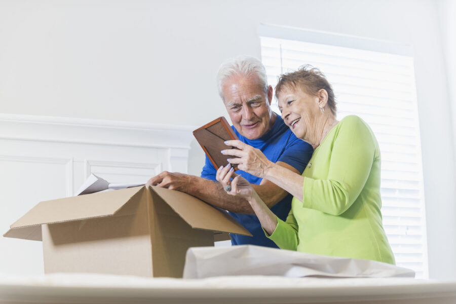 Senior couple packing things to downsize for senior living